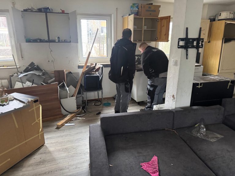 Zwei Mitarbeiter begutachten die Situation nach einem Wasserschaden in einer Wohnung.